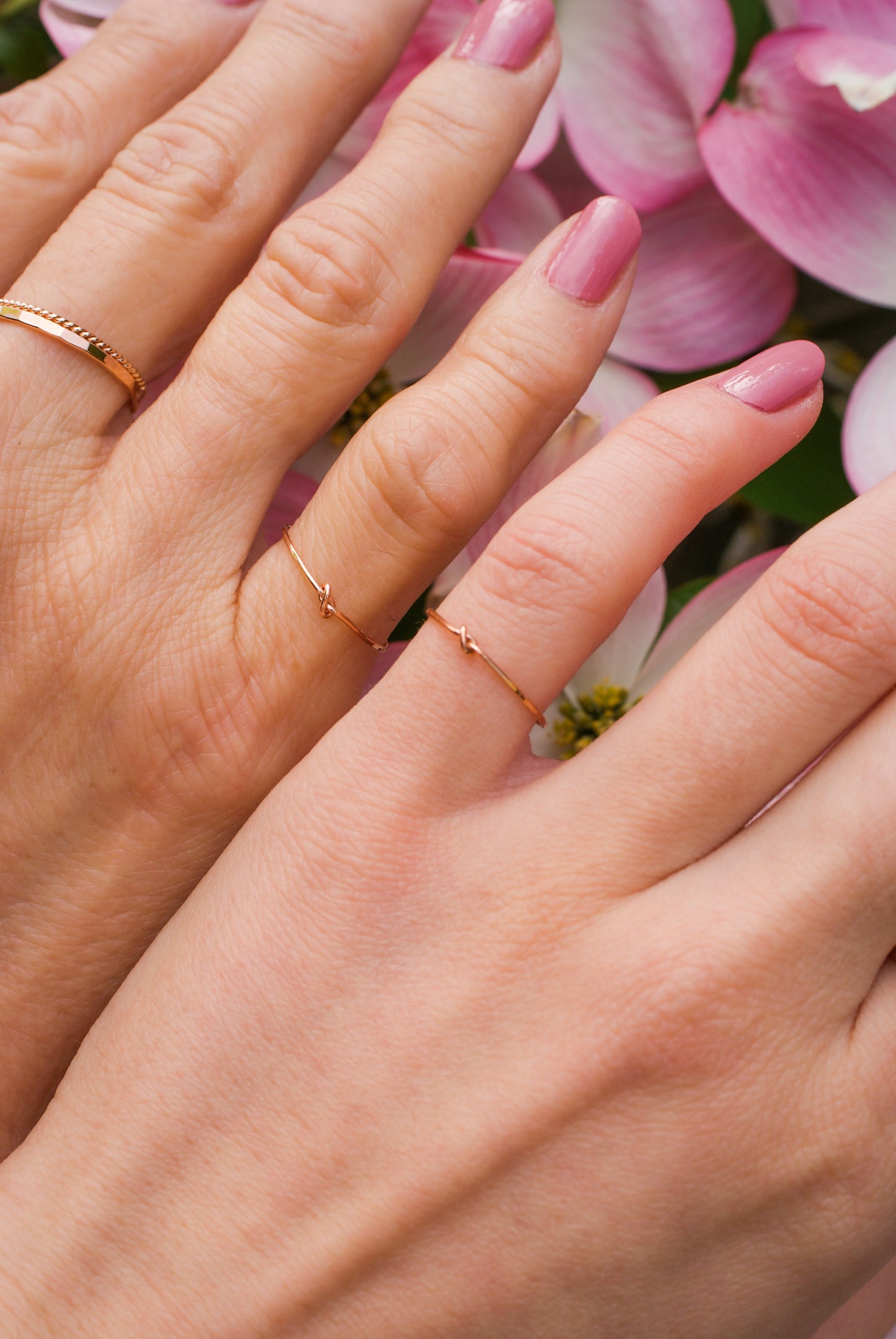 Example of the thin closed knot rings as matching pinky or pinkie rings. Paired with a Thick Hammered Ring and Thin Twist ring in Rose Gold Fill.