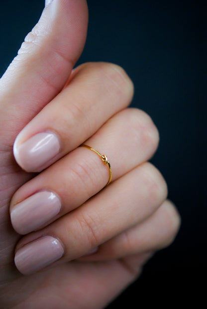 Ultra Thin Closed Knot Ring shown as a Midi or Knuckle Ring on the middle finger knuckle in 14k Gold Fill.