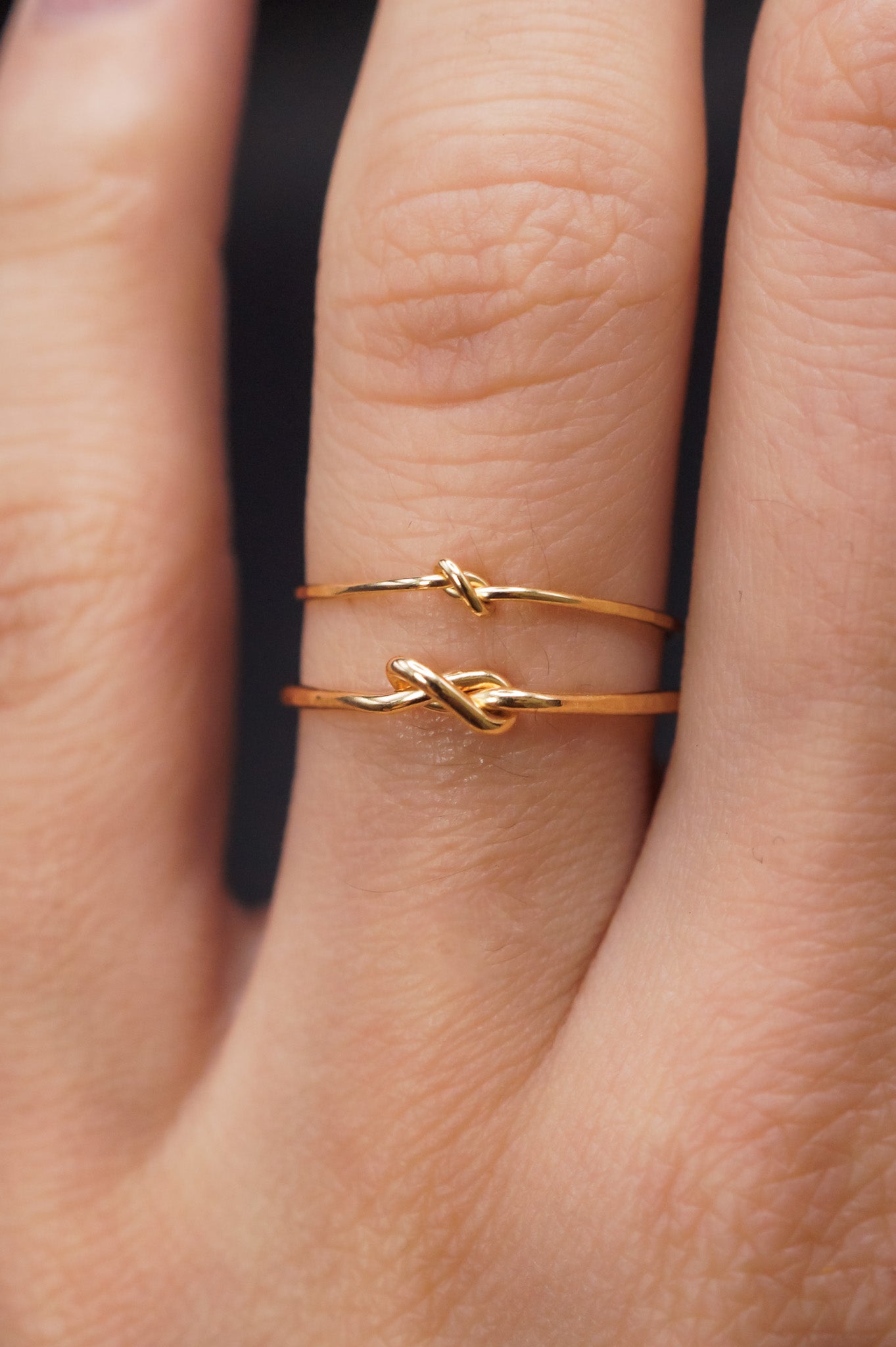 Modeled example of both the Thin and Thick Closed Knot Ring in 14k Gold Fill on ring finger.