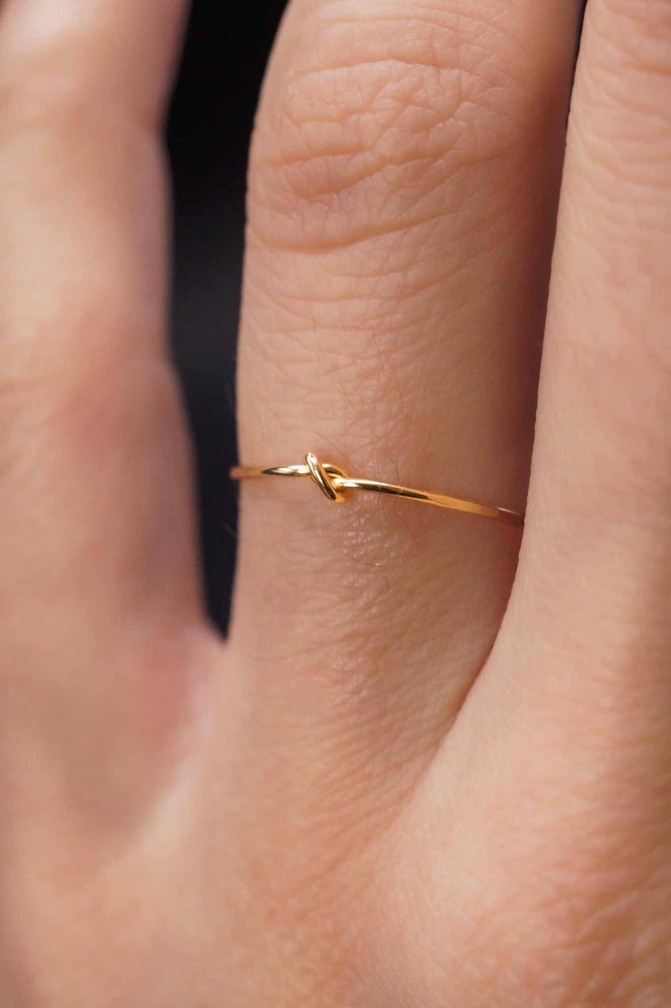 Modeled example of Ultra Thin Closed Knot Ring in 14k Gold Fill on ring finger.