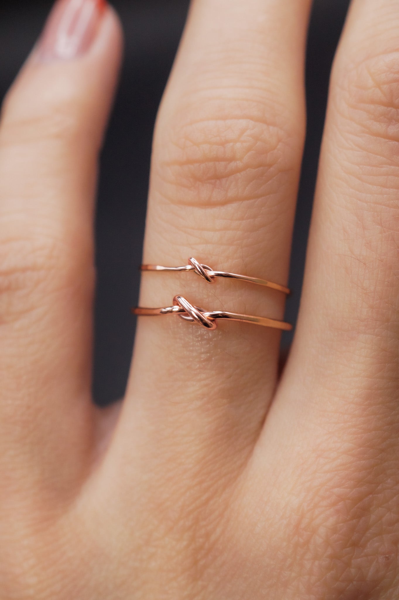 Modeled example of the Thick and Thin  Closed Knot in 14k Rose Gold Fill on the ring finger.
