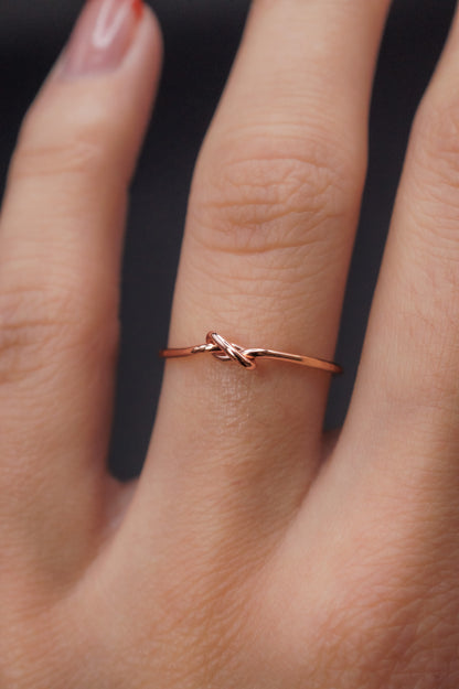 Modeled example of the Thick Closed Knot in 14k Rose Gold Fill on the ring finger.